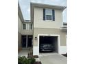 Attached garage of the townhome with a car parked inside at 3032 Inlet Breeze Way, Holiday, FL 34691