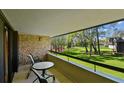 Relax on the balcony with views of lush greenery and the surrounding landscape at 36750 Us Highway 19 N # 01205, Palm Harbor, FL 34684