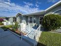 Inviting front exterior featuring well-maintained landscaping and a walkway to the entrance of this lovely home at 38339 Eucalyptus Dr, Zephyrhills, FL 33542