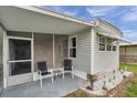 This porch features comfortable seating and plenty of natural light for relaxation at 3834 Kim Dr, Wesley Chapel, FL 33543