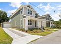 Charming two-story home featuring a spacious front porch and a detached two-car garage with a long driveway at 408 W Paris St, Tampa, FL 33604