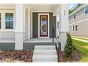 Close-up of the front entrance featuring a red door, white columns, and brick accents at 408 W Paris St, Tampa, FL 33604