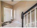 Entryway with staircase, tile flooring, and a view of the front door at 4910 Pond Ridge Dr, Riverview, FL 33578