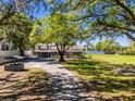 Spacious property with a well-maintained lawn, mature trees, and a long driveway at 498 Lakewood Dr, Brandon, FL 33510