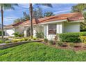 Beautifully landscaped home with a vibrant green lawn and healthy shrubbery at 5473 Blue Heron Ln, Wesley Chapel, FL 33543