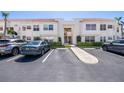 Condominium exterior shows ample parking in front of a well-maintained building with lush landscaping at 6061 Bahia Del Mar Blvd # 112, St Petersburg, FL 33715