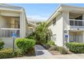 Exterior view of condo showcasing maintained landscaping and building entrances at 6915 Stones Throw N Cir # 3104, St Petersburg, FL 33710