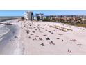 Beautiful beach view with vacationers enjoying sun and sand near buildings and ocean waves at 7050 Sunset Way # 26, St Pete Beach, FL 33706