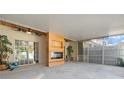 Spacious screened lanai with a modern fireplace, offering a comfortable outdoor living area for relaxation and entertainment at 914 Woodbridge Ct, Safety Harbor, FL 34695