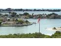 Scenic view of the intercoastal waterway with waterfront homes, docks, and an American flag at 100 Bluff View Dr # 417A, Belleair Bluffs, FL 33770