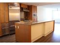 Modern kitchen featuring stainless steel appliances, spacious island, and wood cabinets at 1208 E Kennedy Blvd # 1022, Tampa, FL 33602