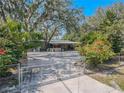 Gated property featuring lush landscaping and a charming single-story home at 12303 Greenland Dr, Riverview, FL 33579