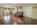 Bright living room featuring hardwood floors, ceiling fan and large windows at 12303 Greenland Dr, Riverview, FL 33579