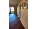Hallway with dark wood floors and a framed picture on the wall at 1601 43Rd N St # 226, St Petersburg, FL 33713