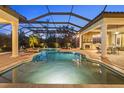 Screened in pool with pavers, outdoor bar and seating area with fireplace at 16312 Palmettoglen Ct, Lithia, FL 33547