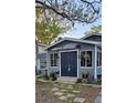 Welcoming home featuring a manicured lawn, complemented by colorful potted plants near the entrance at 1743 Maryland Ne Ave, St Petersburg, FL 33703