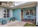 Cozy front porch with seating, a decorative fish, and a welcoming entrance at 22516 Bolanos Ct, Port Charlotte, FL 33952