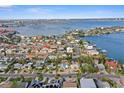 An aerial view of a waterfront community showcasing the homes and proximity to the bay, with clear blue waters at 266 44Th Ave, St Pete Beach, FL 33706