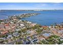 An aerial view of a waterfront community showcases the homes and proximity to the bay, with clear blue waters at 266 44Th Ave, St Pete Beach, FL 33706