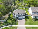 Stunning aerial view of a two-story home with a spacious yard, complemented by mature trees at 2911 Silva Wood Dr, Valrico, FL 33596