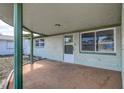 Covered porch with brick detail offers shade and protection from the elements at this home at 3438 Bigelow Dr, Holiday, FL 34691