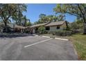 Exterior view of the condo featuring assigned parking spaces and well-maintained landscaping at 4031 Bluff Oak Ct, Palm Harbor, FL 34684