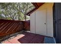 Enclosed outdoor patio features a textured brick floor, privacy fencing, and storage space at 4031 Bluff Oak Ct, Palm Harbor, FL 34684
