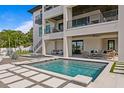 Amazing waterfront pool with stepping stones, and a covered outdoor living and entertaining space at 48 Sandpiper Rd, Tampa, FL 33609