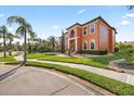 Beautiful terracotta home shows mature landscaping, with palm trees and manicured hedges lining the property at 5910 La Rosa Ln, Apollo Beach, FL 33572