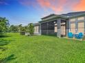 Beautiful backyard with a screened-in patio and lush green lawn perfect for outdoor activities at 6527 Mayport Dr, Apollo Beach, FL 33572