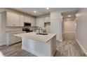 Bright kitchen featuring stainless steel appliances, an island, and light colored cabinetry at 8563 Starlight Loop, Parrish, FL 34219