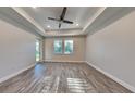 Spacious living room featuring wood-style tile flooring, recessed lighting, and a ceiling fan at 8563 Starlight Loop, Parrish, FL 34219