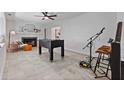 Cozy living room featuring a fireplace, stylish seating, and entertainment options such as a foosball table at 9067 Cypress Trl, Seminole, FL 33777