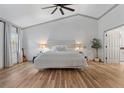 Bright and spacious bedroom with hardwood floors, vaulted ceiling, and large window with curtains at 9067 Cypress Trl, Seminole, FL 33777