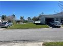 A well-manicured lawn fronts this home, with an attached garage, and a scenic pond just across the street at 10002 Daffodil N St # 51, Pinellas Park, FL 33782