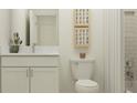 Modern bathroom features white cabinetry, a white countertop, framed art, and a shower with subway tile at 11563 71St E Ave, Palmetto, FL 34221