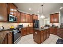 Well-equipped kitchen featuring stainless steel appliances, granite countertops, and central island at 12339 Silton Peace Dr, Riverview, FL 33579