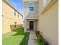 Welcoming front entrance with well-kept lawn and landscaped walkway at 14422 Scottburgh Glen Dr, Wimauma, FL 33598