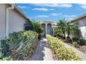 Charming front entrance with paver walkway, landscaping, and welcoming nautical decor at 15657 Aurora Lake Cir, Wimauma, FL 33598