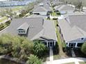 Aerial view showcases the home's location within a well-maintained community with neatly manicured lawns and mature trees at 203 Oceania Ct, Apollo Beach, FL 33572