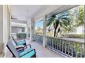 Relaxing screened porch featuring comfortable seating and a view of the lush landscaping and nearby homes at 203 Oceania Ct, Apollo Beach, FL 33572