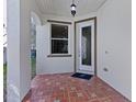 Charming front porch with decorative tile flooring and a stylish front door at 2442 Silvermoss Dr, Wesley Chapel, FL 33544