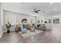 Bright living room featuring hardwood floors, neutral paint and a ceiling fan at 2442 Silvermoss Dr, Wesley Chapel, FL 33544
