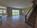 Expansive living room filled with natural light, featuring tile flooring and sliding glass doors to outdoors at 2595 Wise River Ln, Zephyrhills, FL 33541