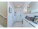 Bright foyer featuring tile flooring, modern lighting, and stylish decor at 30226 Merilee Pl, Wesley Chapel, FL 33545