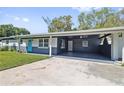 Charming single-story home featuring a spacious carport and lush lawn with curb appeal at 311 W Fern St, Tampa, FL 33604