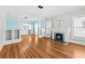 Open-concept living room with hardwood floors, fireplace, and bright blue accent walls at 322 11Th N Ave, St Petersburg, FL 33701