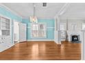 Bright living room with hardwood floors, modern light fixture, and large windows offering plenty of natural light at 322 11Th N Ave, St Petersburg, FL 33701