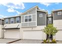 Modern townhome boasting two-car garage, stylish gray and white exterior, and newly installed landscaping at 3473 Timber Crossing Ave, Brandon, FL 33511