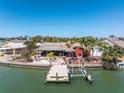 Stunning waterfront home with a dock and tiki hut for outdoor entertaining at 351 S Julia Cir, St Pete Beach, FL 33706